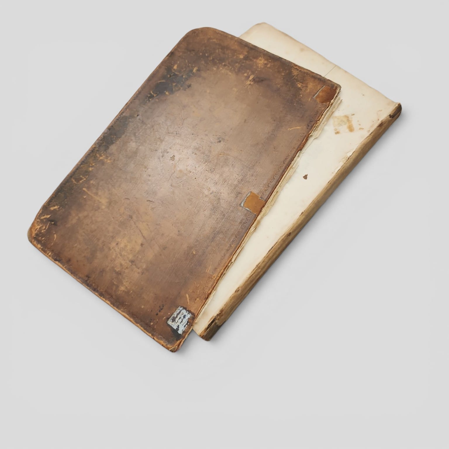 Antique cookbook showing detached board and worn binding
