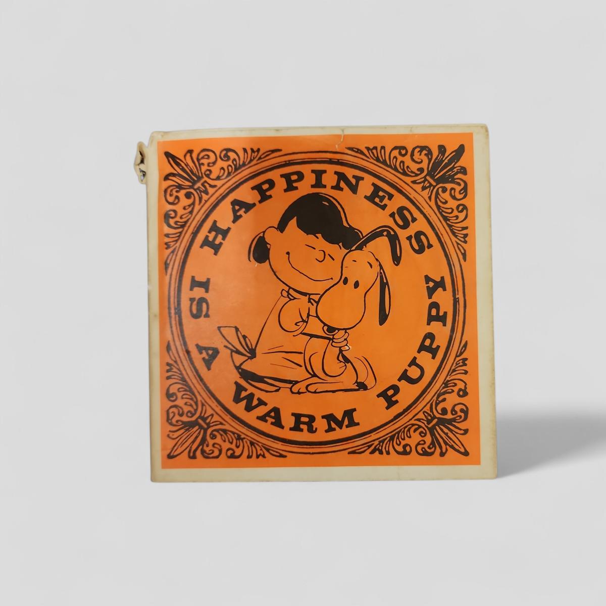 Happiness Is A Warm Puppy by Charles M. Schulz - book cover