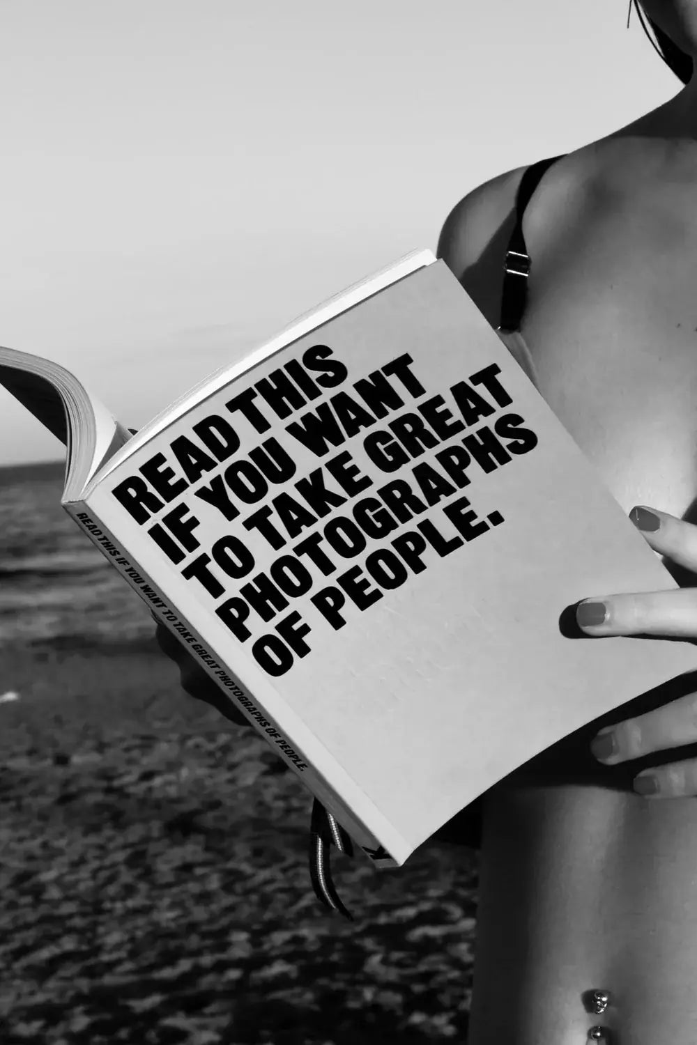 A reader holds a book about portrait photography.